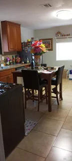 a dining room filled with furniture and a window