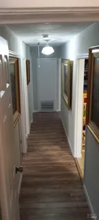 a view of a refrigerator in kitchen and wooden floor