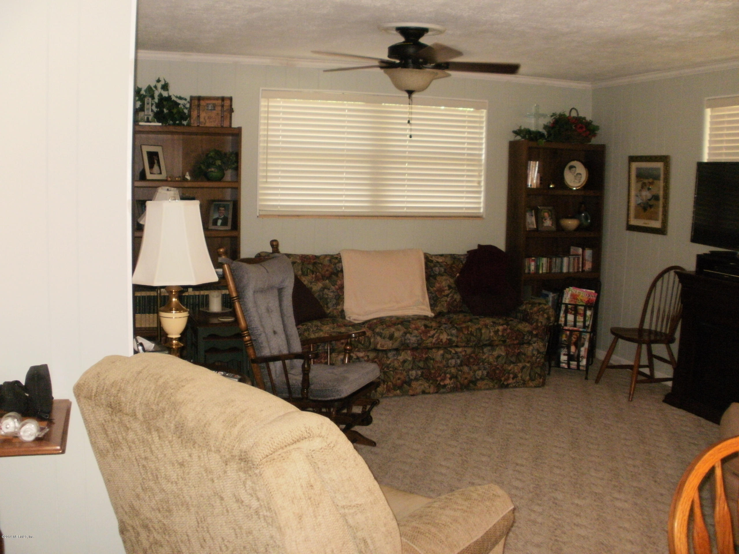 10535 Dodd Road Jacksonville, FL 32218 - Photo 25 of 35 a bedroom with furniture and a window