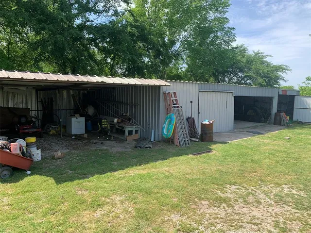 a view of a backyard with a patio and a slide