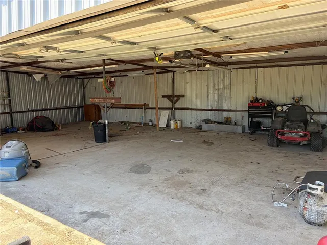 a backyard of a house with barbeque oven and outdoor seating