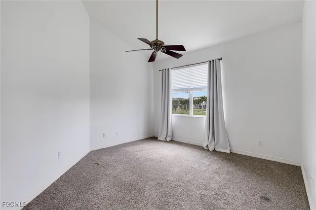an aerial view of a house with a garden and lake view