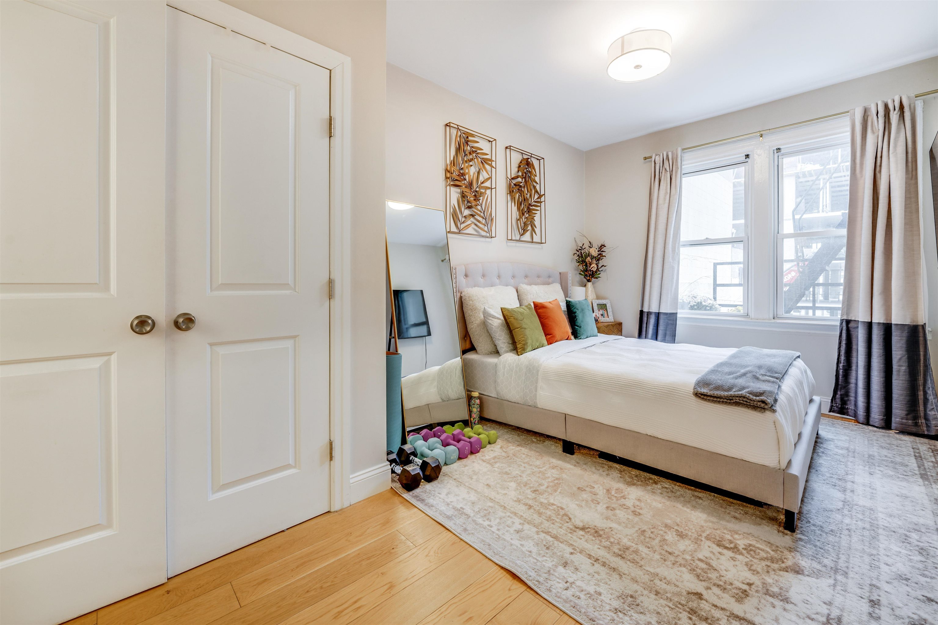 709 Monroe Street, Unit 2 Hoboken, NJ 07030 - Photo 11 of 22 a bed room with a bed and a large window