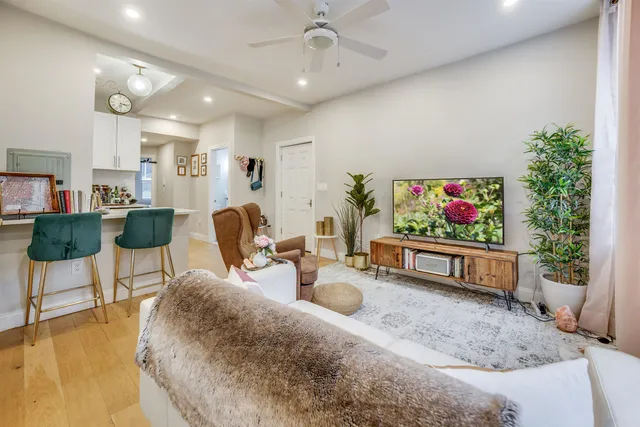 a living room with furniture and a potted plant