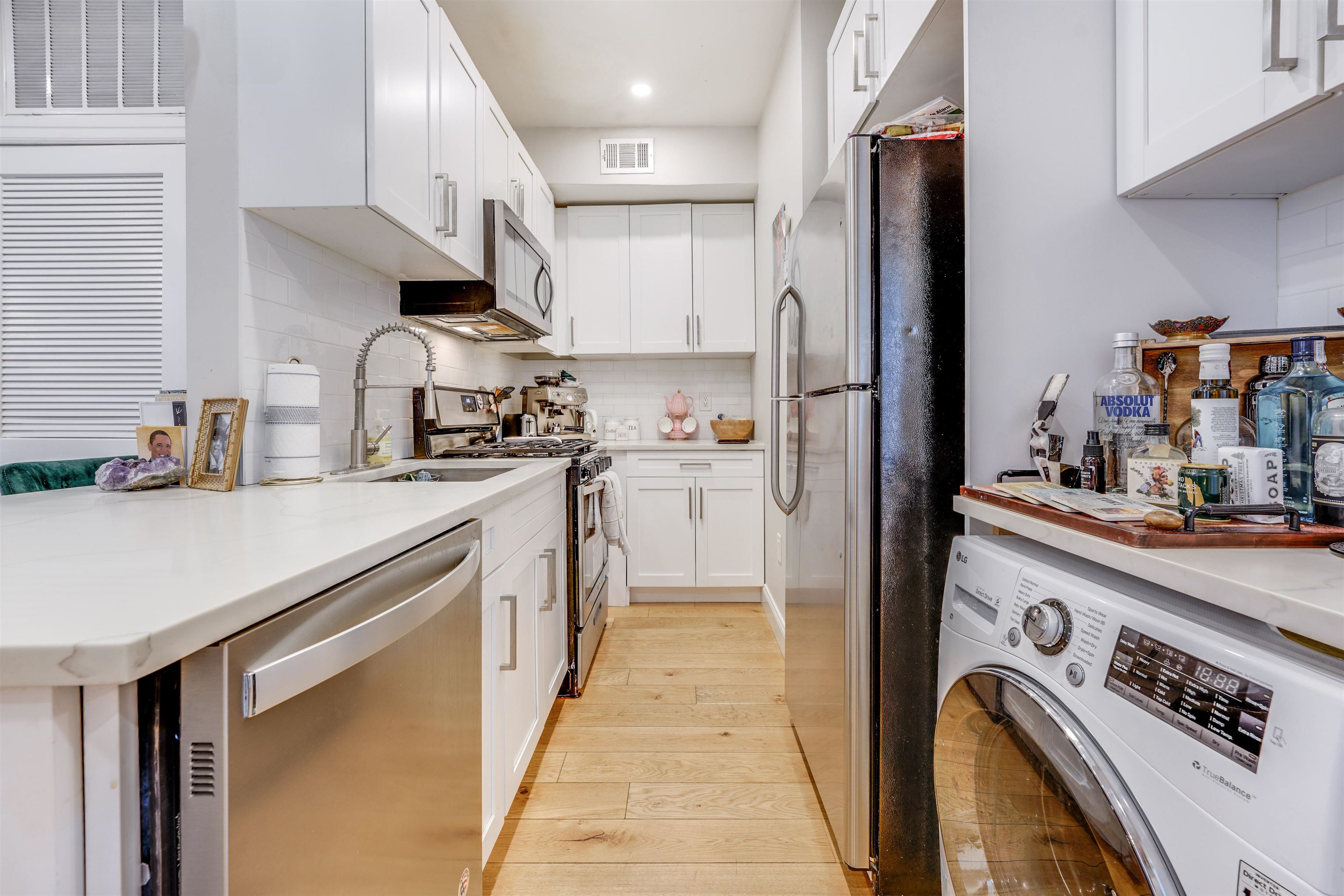709 Monroe Street, Unit 2 Hoboken, NJ 07030 - Photo 9 of 22 a kitchen with stainless steel appliances granite countertop a sink a stove and refrigerator