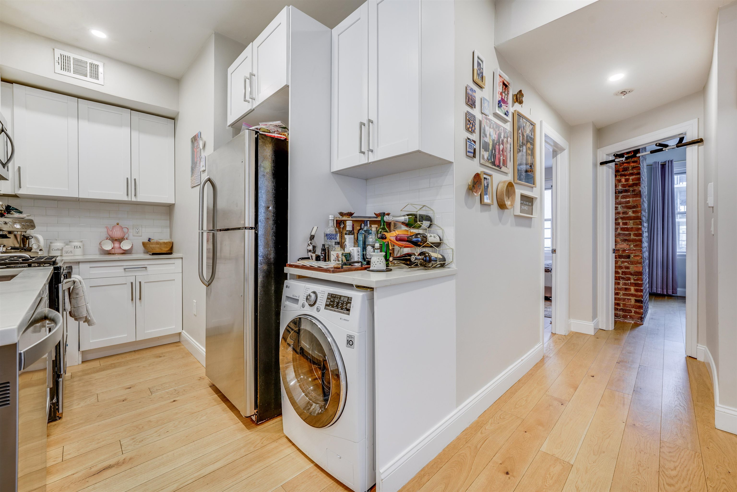 709 Monroe Street, Unit 2 Hoboken, NJ 07030 - Photo 10 of 22 a view of a kitchen with refrigerator and wooden floor
