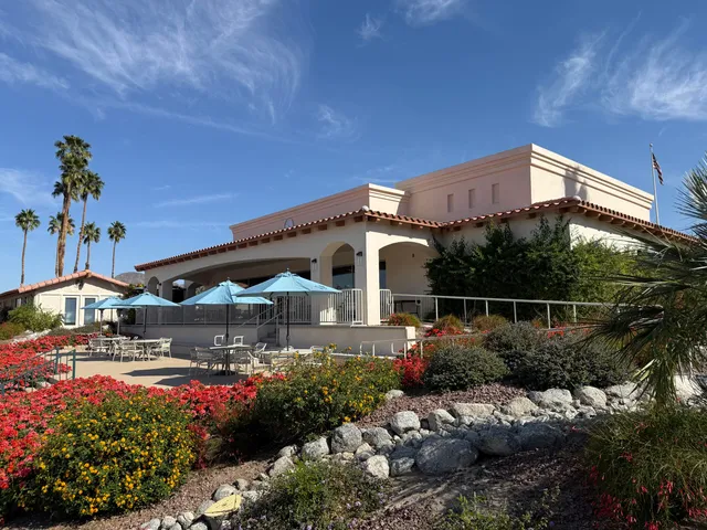 a view of a chairs and table in the backyard