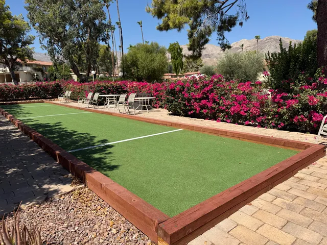 a view of a golf course with a house in the background