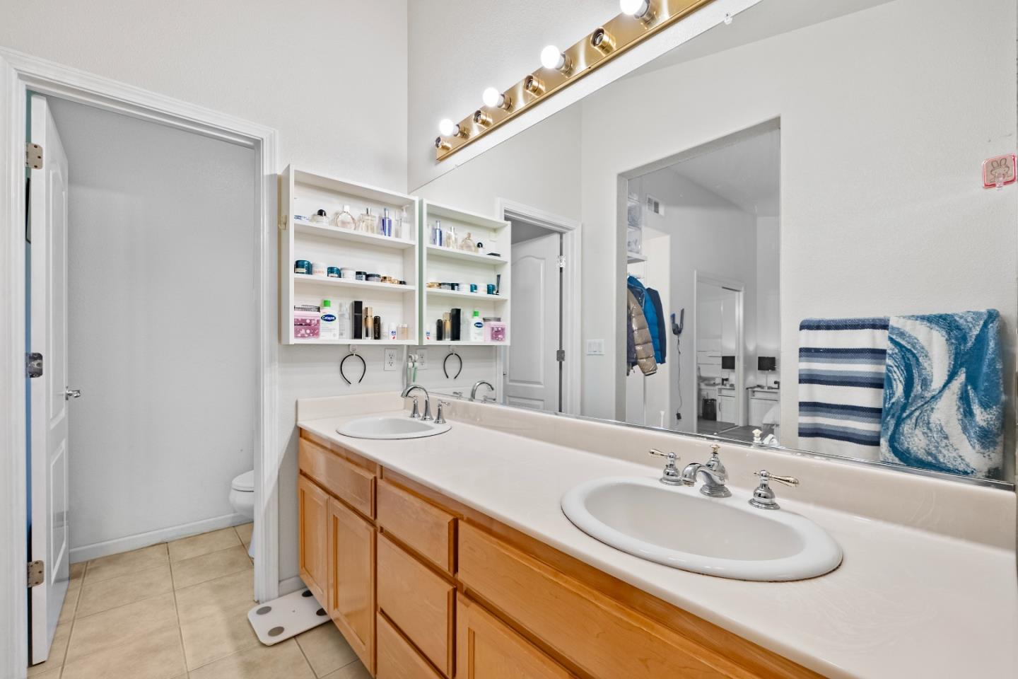 708 Raineer Court San Leandro, CA 94577 - Photo 18 of 32 a bathroom with a double vanity sink and a mirror