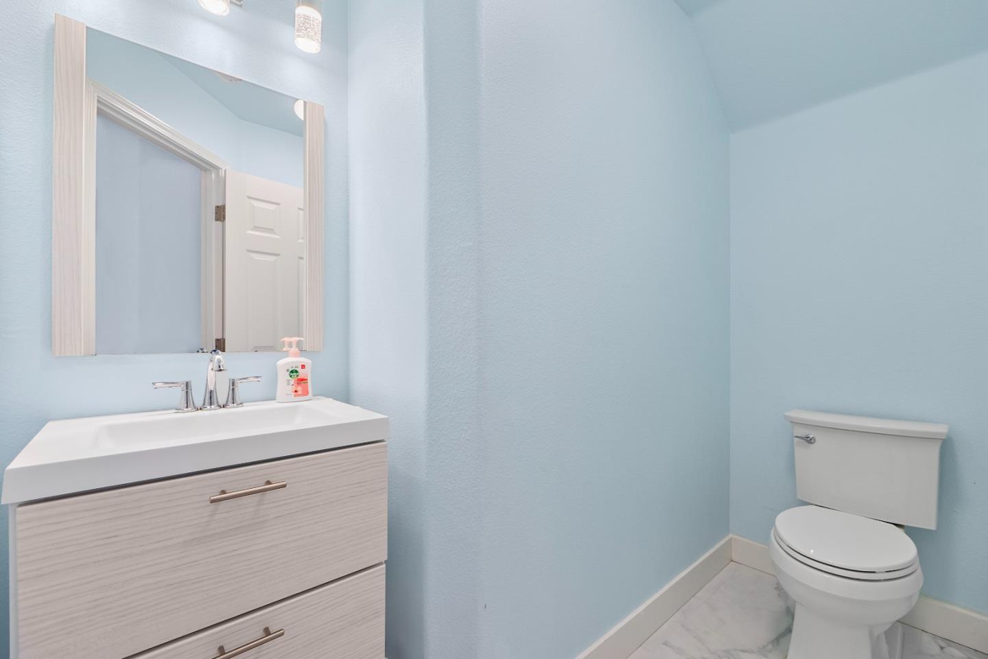 708 Raineer Court San Leandro, CA 94577 - Photo 25 of 32 a bathroom with a toilet sink and mirror