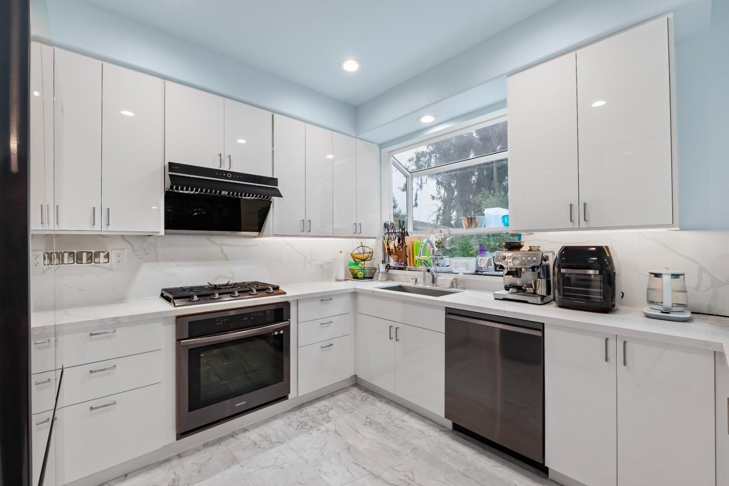 708 Raineer Court San Leandro, CA 94577 - Photo 5 of 32 a kitchen with cabinets stainless steel appliances and wooden floor