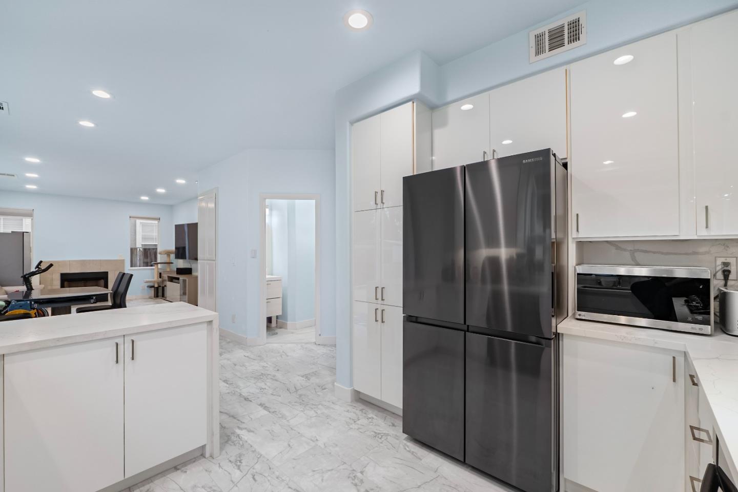 708 Raineer Court San Leandro, CA 94577 - Photo 7 of 32 a kitchen with stainless steel appliances a refrigerator sink and microwave