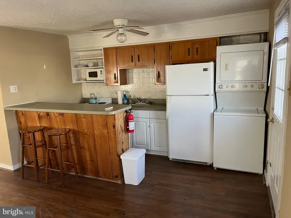 a white refrigerator freezer sitting inside of a kitchen