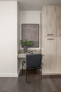 a room with a couch and a potted plant next to a window