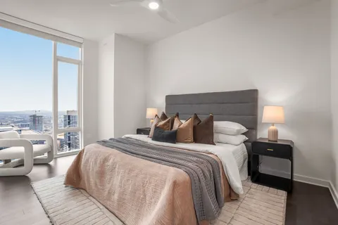 a bedroom with a bed and a night stand