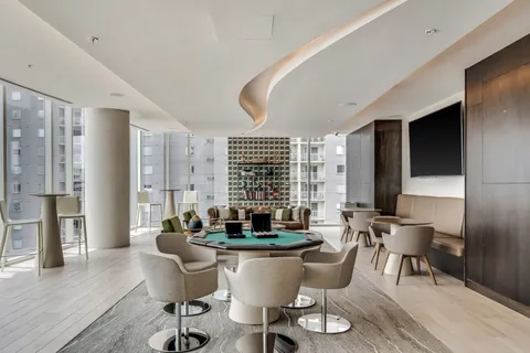 a room with pool table and windows