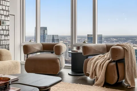 a balcony with furniture and a large window