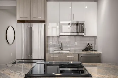 a kitchen with cabinets and a stove top oven
