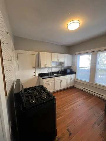 a kitchen with granite countertop a refrigerator stove and sink