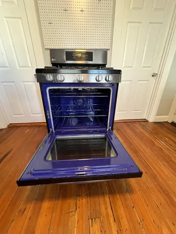 a view of a kitchen with furniture and wooden floor