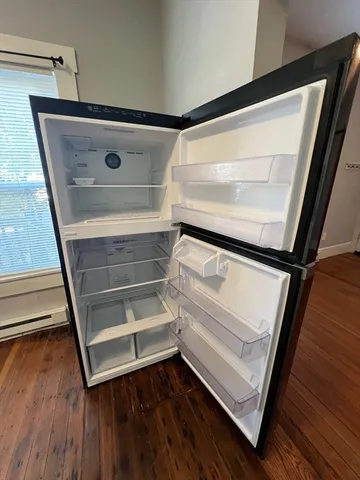 a view of walk in closet with wooden floor and chair