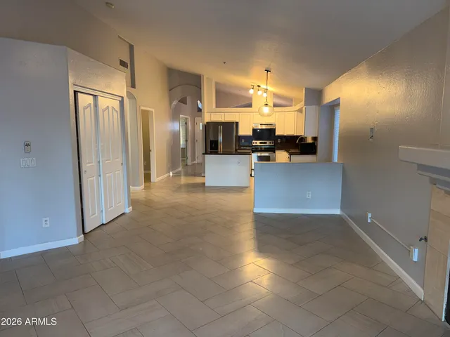 a view of a living room kitchen and a refrigerator