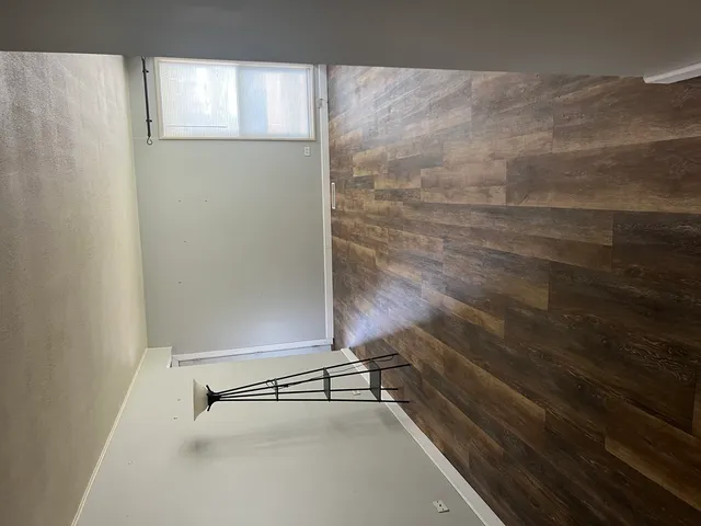 a view of a room with wooden floor