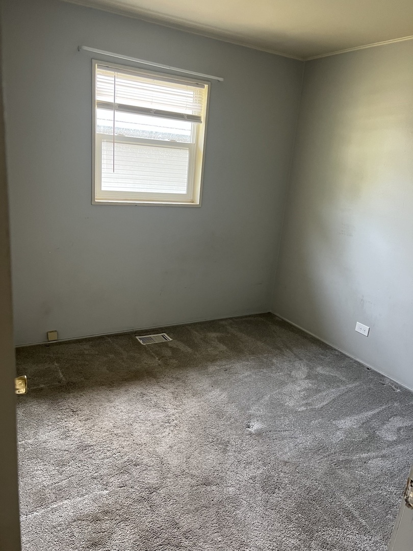 2713 Wilke Road Rolling Meadows, IL 60008 - Photo 5 of 9 an empty room with a window