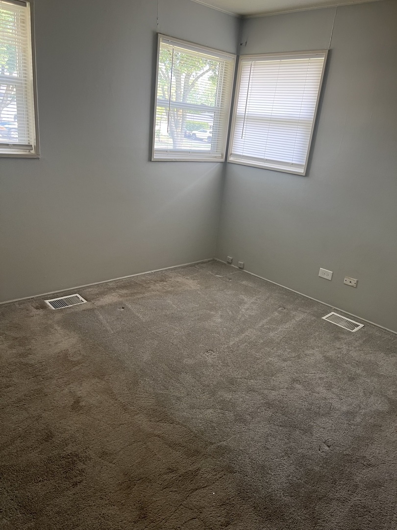 2713 Wilke Road Rolling Meadows, IL 60008 - Photo 6 of 9 an empty room with windows
