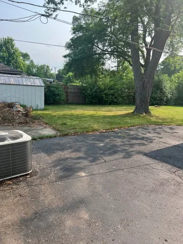 a view of a yard with swimming pool and sitting area