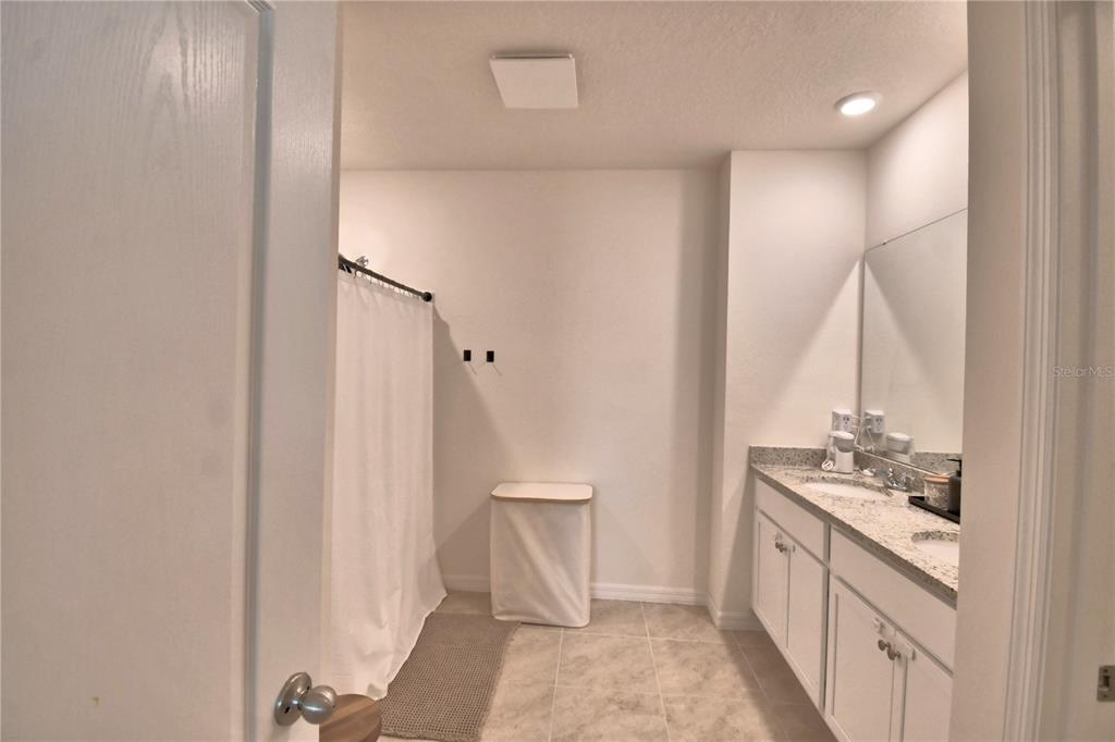 2839 Moulin Road Davenport, FL 33837 - Photo 36 of 75 a bathroom with a sink and a mirror