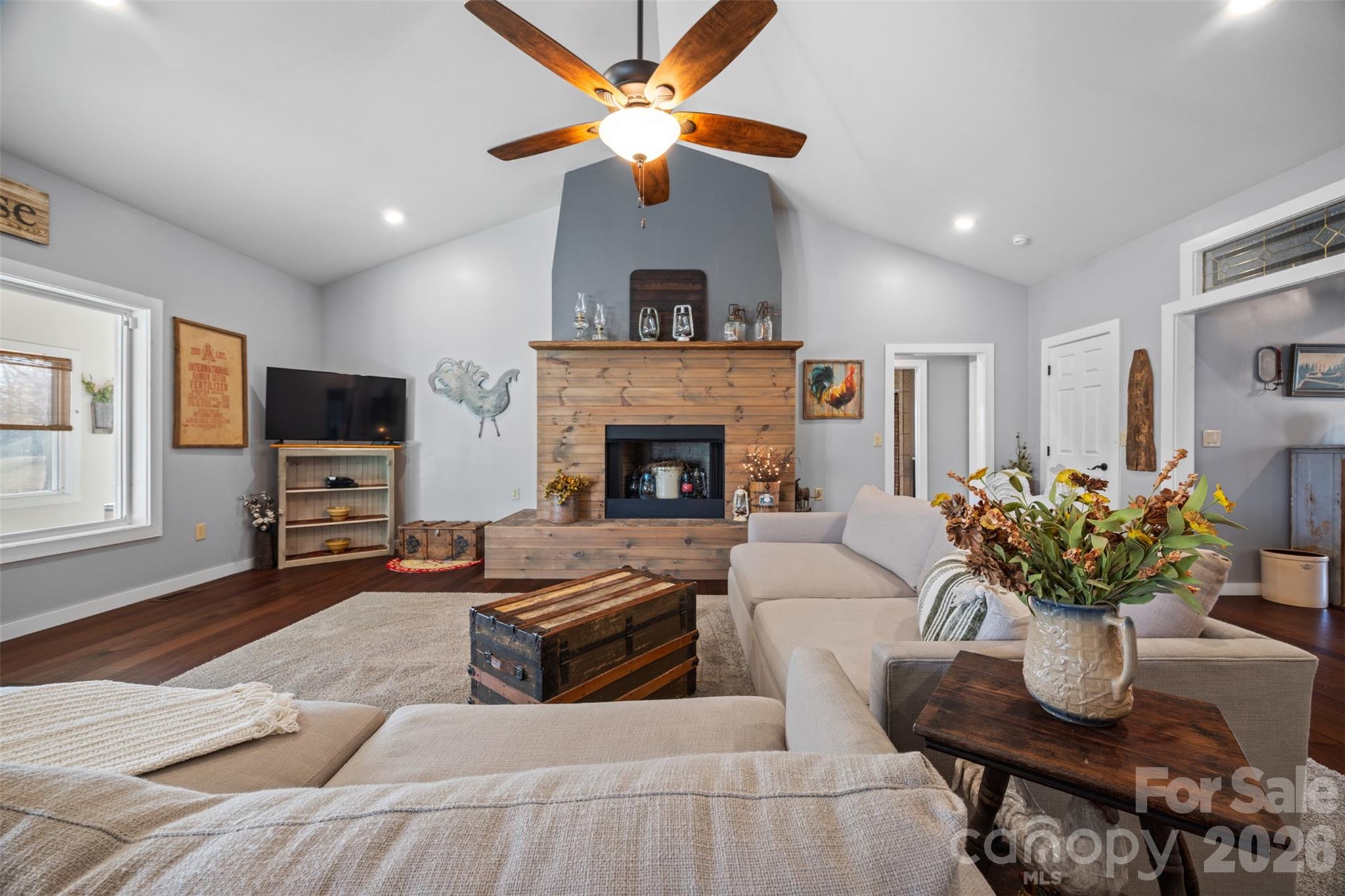 445 Warren Road Taylorsville, NC 28681 - Photo 13 of 48 a living room with furniture a fireplace and a flat screen tv