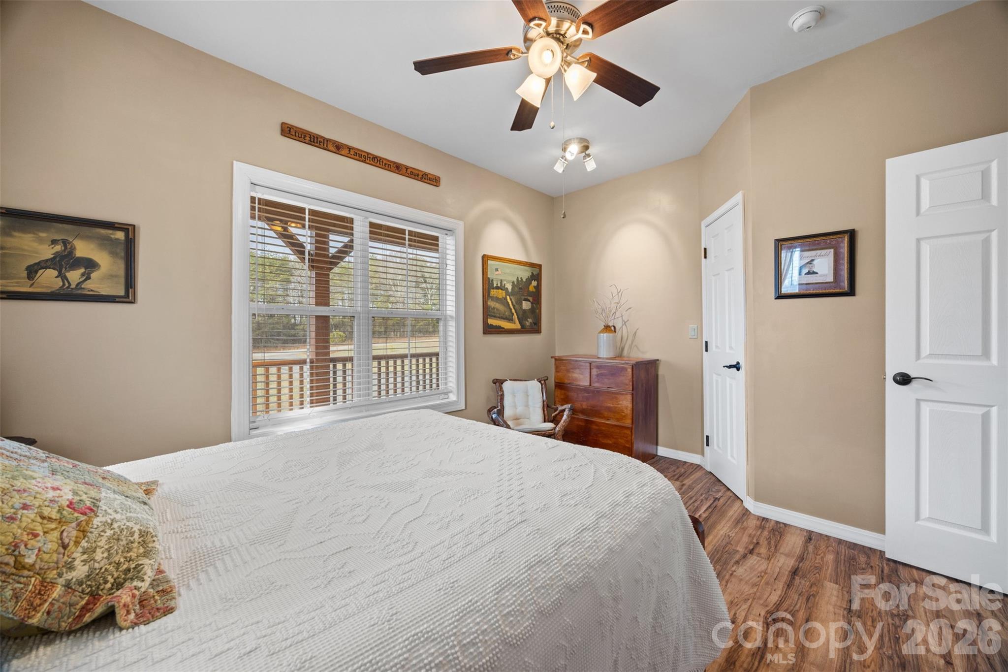 445 Warren Road Taylorsville, NC 28681 - Photo 32 of 48 a bedroom with a large bed and a chandelier