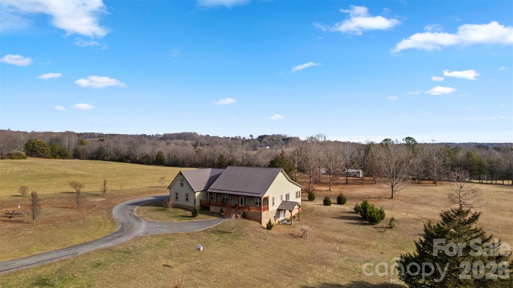445 Warren Road Taylorsville, NC 28681 - Photo 6 of 48 a view of a lake with couches and table