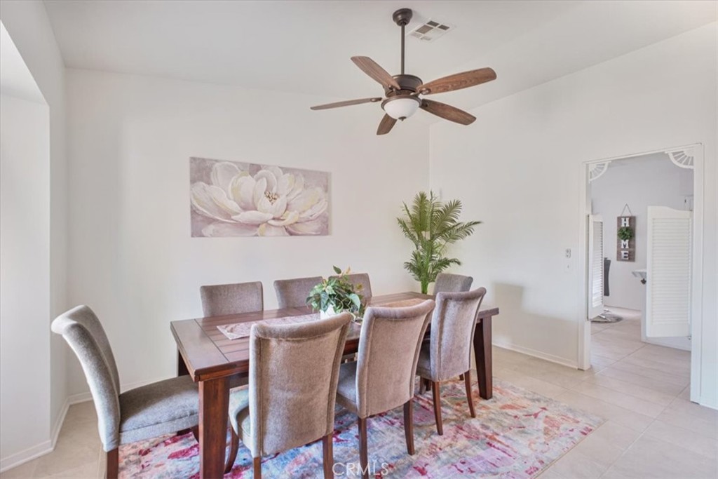 79040 Cliff Street Bermuda Dunes, CA 92203 - Photo 14 of 42 a view of a dining room with furniture and a chandelier fan