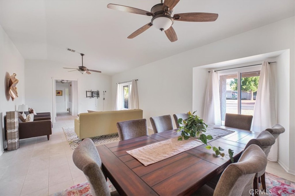79040 Cliff Street Bermuda Dunes, CA 92203 - Photo 15 of 42 a view of a livingroom and dining room with furniture wooden floor a chandelier