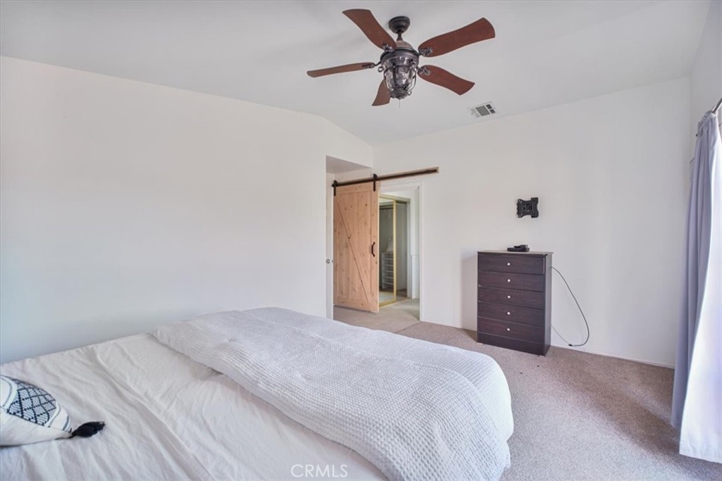 79040 Cliff Street Bermuda Dunes, CA 92203 - Photo 23 of 42 a bedroom with a large bed and a chandelier