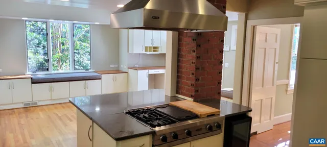a kitchen with stainless steel appliances granite countertop a stove and a refrigerator