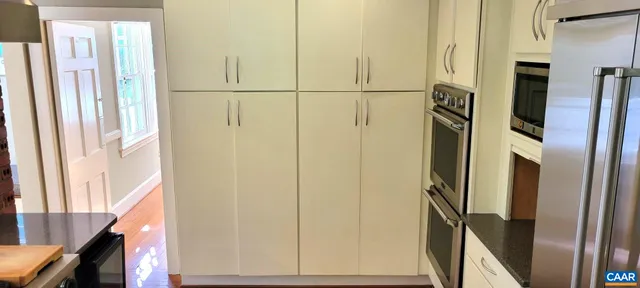 a view of a refrigerator in kitchen and an window