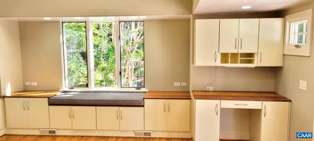 a kitchen with a window a sink and a counter