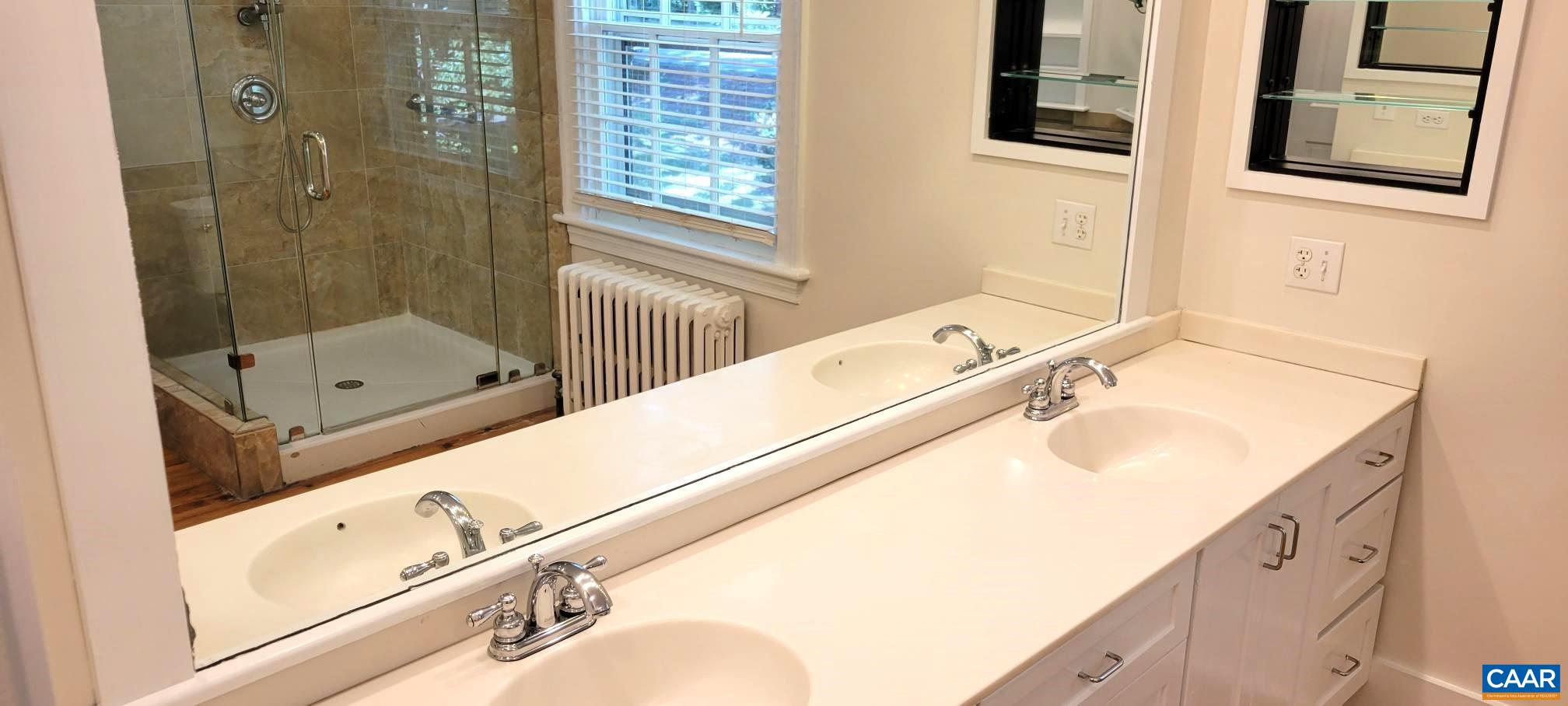 1912 Blue Ridge Road Charlottesville, VA 22903 - Photo 34 of 49 a bathroom with a tub sink and mirror