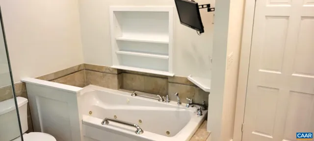 a bathroom with a tub sink and toilet