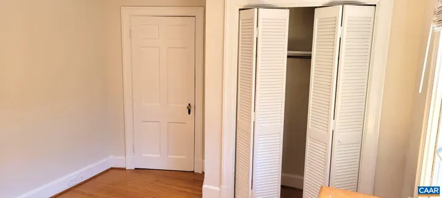 a view of front door with wooden floor