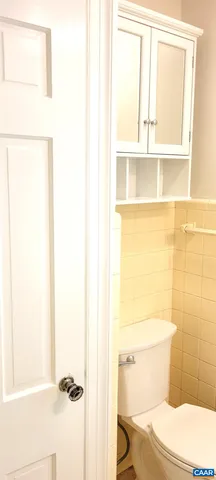 a bathroom with a toilet and a window