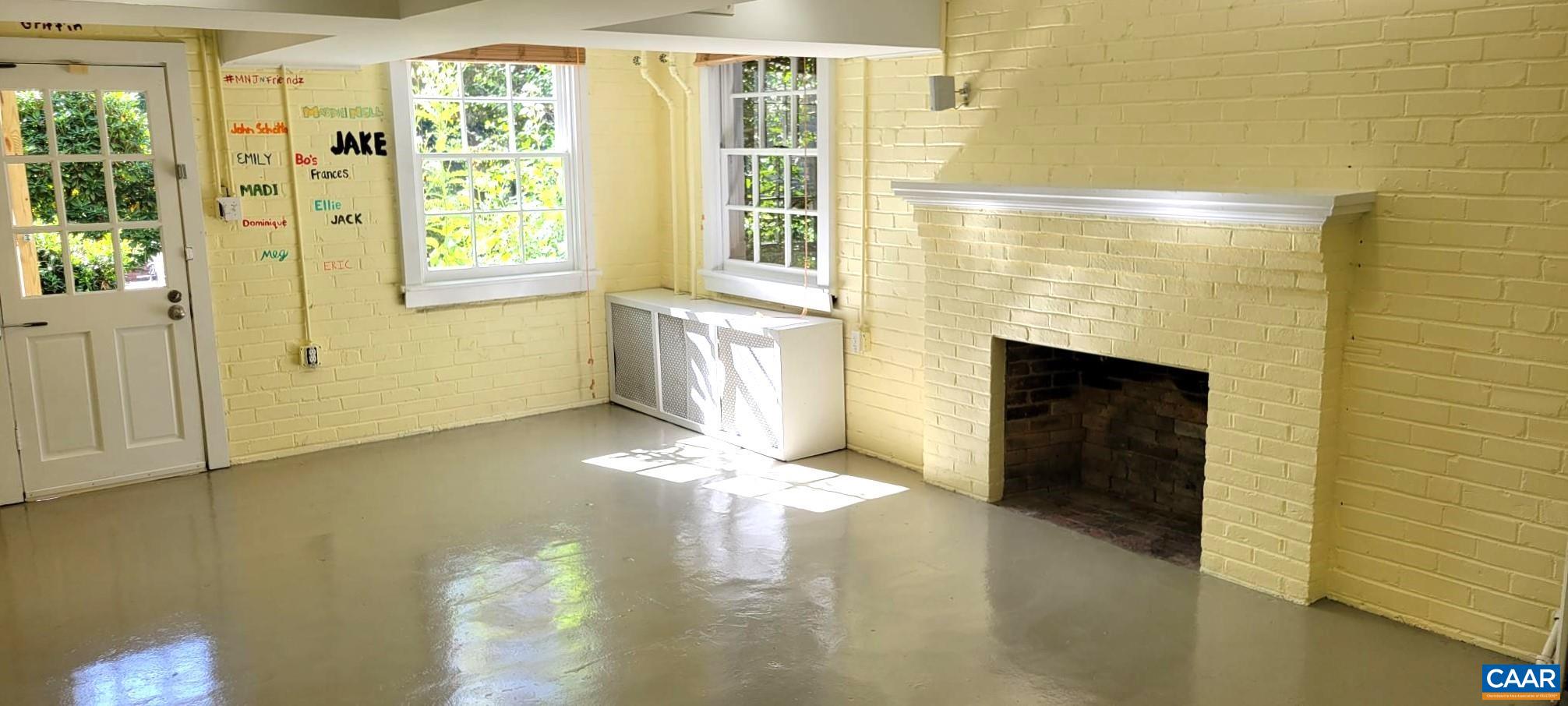 1912 Blue Ridge Road Charlottesville, VA 22903 - Photo 43 of 49 a view of an empty room with a fireplace and a window