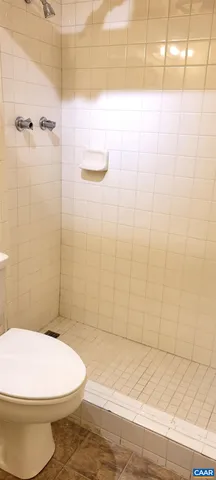 a bathroom with a toilet and shower