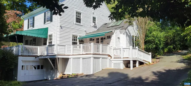 a view of a white house with large windows