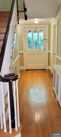 a view of an entryway with wooden floor and door