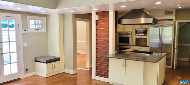 a kitchen with stainless steel appliances granite countertop a refrigerator and a sink
