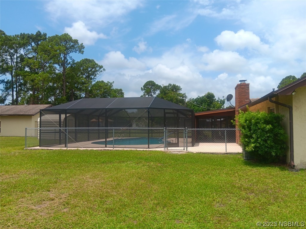 4141 Sterling Street Mims, FL 32754 - Photo 18 of 20 a swimming pool with lots of tress in front of it